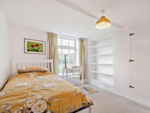 a white bedroom with a bed and a window at 2 Bed in Swindon oc-93489 in Bishopstone