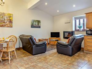 a living room with two chairs and a table at 2 Bed in Ellesmere oc-94418 in Dodleston