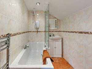 a bathroom with a tub and a sink at 2 Bed in Ellesmere oc-94418 in Dodleston +29 photos
