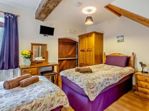 a bedroom with two beds and a desk at 2 Bed in Ellesmere oc-94418 in Dodleston