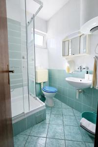 a bathroom with a toilet and a sink and a shower at Orange city apartment's Repić in Biograd na Moru +46 photos