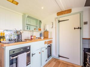 a kitchen with white cabinets and a black oven at 1 Bed in Hereford oc-79575 in Byford +14 photos