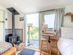 a bedroom with a bed and a desk and a fireplace at 1 Bed in Hereford oc-79575 in Byford