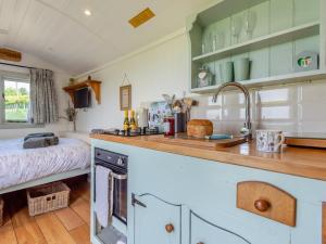 a kitchen with a sink and a bed in a room at 1 Bed in Hereford oc-79575 in Byford