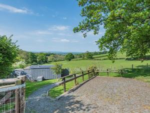 a farmhouse with a fence and a field at 1 Bed in Hereford oc-79575 in Byford