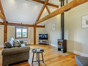 a living room with a couch and a wood stove at 1 Bed in Bucknell oc-94662 in Letton