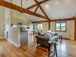 a living room with a couch and a kitchen at 1 Bed in Bucknell oc-94662 in Letton