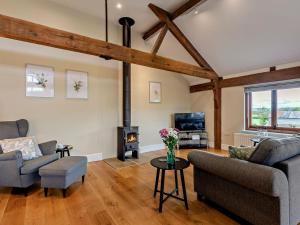 a living room with two couches and a wood stove at 1 Bed in Bucknell oc-94661 in Letton