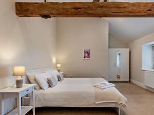 a bedroom with a large white bed and a table at 1 Bed in Bucknell oc-94661 in Letton