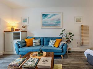a living room with a blue couch and a table at 1 Bed in Kidderminster oc-94769 in Orleton +24 photos