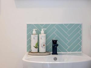 a bathroom sink with two bottles on top of it at 1 Bed in Kidderminster oc-94769 in Orleton