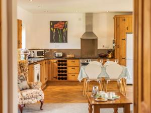 a kitchen with a table and chairs and a stove at 1 Bed in Ludlow oc-chl23 in Orleton +6 photos