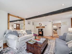 a living room with a white couch and a table at 1 Bed in Frome oc-91715 in Woolverton