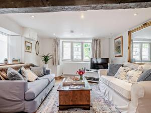 a living room with two couches and a tv at 1 Bed in Frome oc-91715 in Woolverton