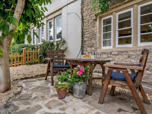 a patio with two benches and a table and chairs at 1 Bed in Frome oc-91715 in Woolverton