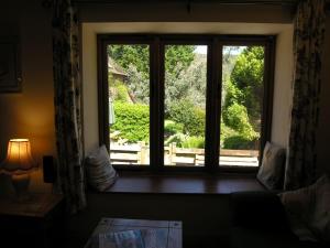 a window in a room with a view of a garden at Selworthy- Ukc4915 in Timberscombe