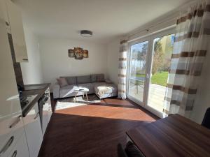 a living room with a couch and a table at Seeschwalbe in Graal-Müritz