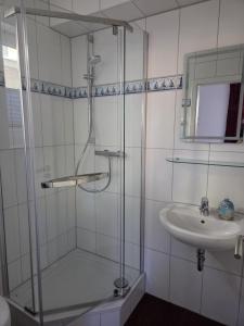 a bathroom with a shower and a sink at Seeschwalbe in Graal-Müritz +11 photos