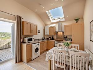 a kitchen with a table and a dining room at 2 Bed in Blakeney oc-54765 in Awre