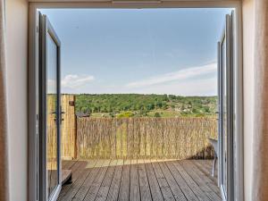an open door to a deck with a fence at 2 Bed in Blakeney oc-54765 in Awre