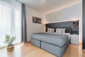 a bedroom with a large bed in a room at V7 Boutique Appartements in Freiburg im Breisgau