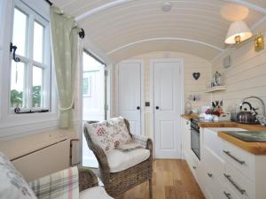 a kitchen with a chair in a tiny house at 1 Bed in Hereford oc-44235 in Longtown