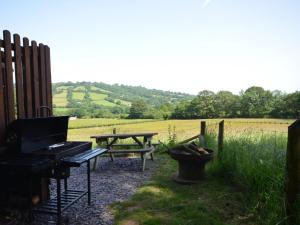 a patio with a picnic table and a picnic bench at 1 Bed in Hereford oc-44235 in Longtown +7 photos