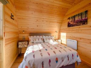 a bedroom with a bed in a wooden cabin at 1 Bed in Alfreton oc-90518 in South Wingfield