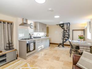 a kitchen and living room with a table and a stove at 1 Bed in Hereford oc-87736 in Moccas
