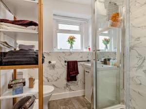 a bathroom with a shower and a toilet and a sink at 2 Bed in High Peak oc-94131 in Buxworth +14 photos