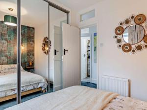 a bedroom with a mirror and a bed at 2 Bed in High Peak oc-94131 in Buxworth
