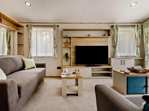 a living room with a couch and a flat screen tv at 3 Bed in Shrewsbury oc-94112 in Bromlow