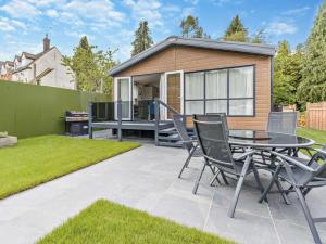 a patio with a table and chairs in front of a house at 3 Bed in Shrewsbury oc-94112 in Bromlow