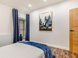 a bedroom with a bed and a picture on the wall at 2 Bed in High Peak oc-94058 in New Mills