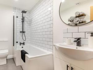 a white bathroom with a sink and a mirror at 2 Bed in High Peak oc-94058 in New Mills +11 photos