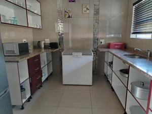 a kitchen with a white refrigerator and a sink at Shotleft on Wye RD in Margate