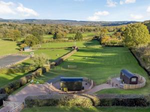 an aerial view of a large green field with buildings at 1 Bed in Hereford oc-93441 in Little Dewchurch +16 photos