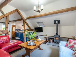 a living room with a red couch and a wood stove at 2 Bed in Kidderminster oc-cc090 in Bayton