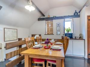 a dining room and kitchen with a wooden table and chairs at 2 Bed in Kidderminster oc-cc090 in Bayton +14 photos