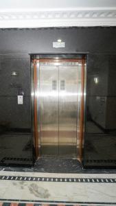 a elevator in a building with a metal door at Hotel The Black Diamond in Bangalore