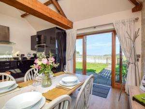 a kitchen and dining room with a table and chairs at 2 Bed in Evesham oc-89305 in Church Lench