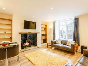 a living room with a couch and a fireplace at 2 Bed in Ilkley oc-89554 in Ilkley