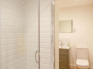 a bathroom with a shower with a toilet and a sink at 2 Bed in Ilkley oc-89554 in Ilkley +6 photos