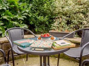 a table with a bowl of fruit and books on it at 2 Bed in Ilkley oc-89554 in Ilkley