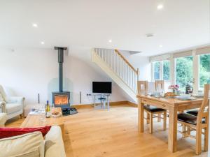 a living room with a table and a fireplace at 2 Bed in Bristol oc-72582 in Winford