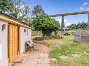 a house with a chair in a yard at 2 Bed in Bristol oc-72582 in Winford