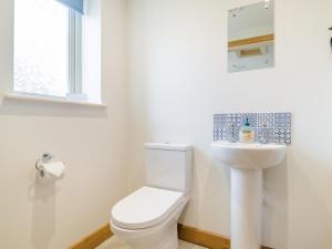 a white bathroom with a toilet and a sink at 2 Bed in Bristol oc-72582 in Winford +10 photos