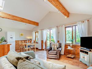 a living room with a couch and a table at 2 Bed in Ledbury oc-77377 in Yatton