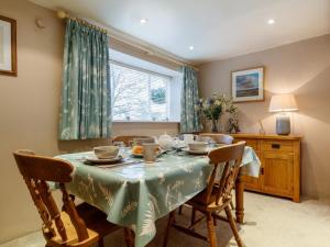 a dining room with a table and chairs and a window at 2 Bed in Evesham oc-49245 in Cleeve Prior +13 photos