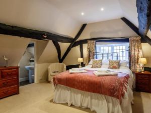 a bedroom with a large bed in a attic at 2 Bed in Evesham oc-49245 in Cleeve Prior